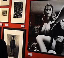 Unknown man looking at Art work of Helmut Newton worth $125.000 by Anton Oparin