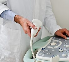 A doctor with echography equipment by viappy