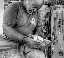 Wood Sculptor at work in Nassau, The Bahamas by 242Digital