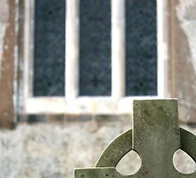 Celtic headstone and church window, Clayton Churchyard, Sussex by Maxine Collins