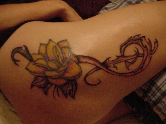 Lotus with treble clef tattoo. This is on my wife's upper thigh area, 