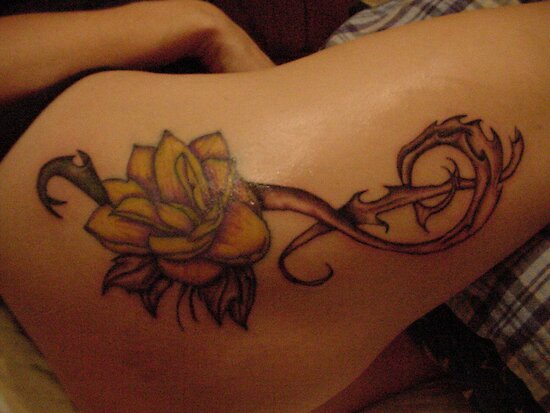 Lotus with treble clef tattoo. This is on my wife's upper thigh area,