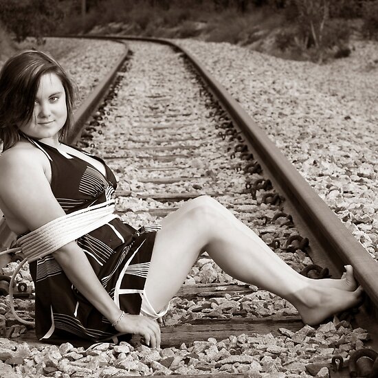 work.4110612.1.flat,550x550,075,f.tied-up-on-train-tracks.jpg